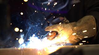 An IEM employee in the midst of welding