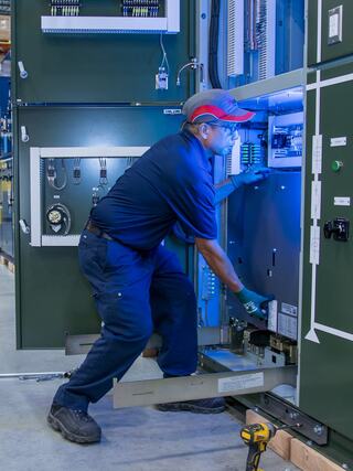 An IEM employee working with equipment