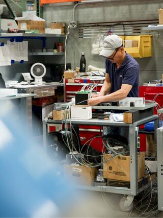 IEM employee working with components